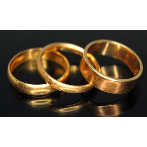 172 - Two hallmarked 22ct gold wedding bands, wt. 5.7g, and one hallmarked 18ct gold, wt. 4.2g, sizes J- L... 