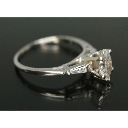 218 - A diamond solitaire ring, the oval cut central stone weighing approx. 0.79 carats, diamond set shoul... 