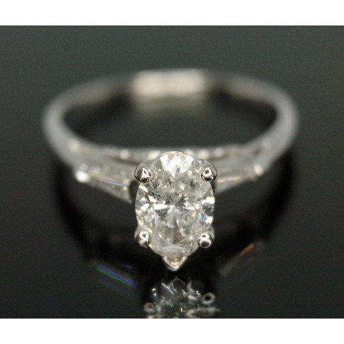 218 - A diamond solitaire ring, the oval cut central stone weighing approx. 0.79 carats, diamond set shoul... 