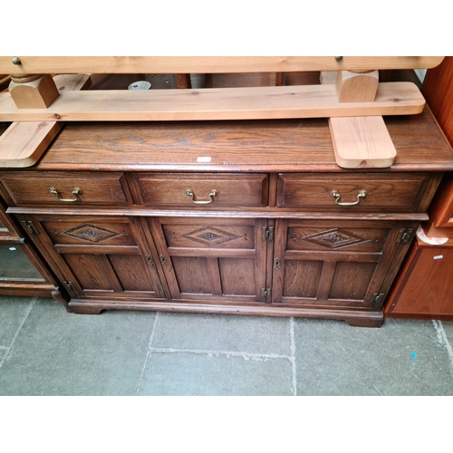 879 - An aged oak sideboard.