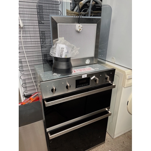 A Baumatic, model B0992SS double oven with hood, trays, etc.
