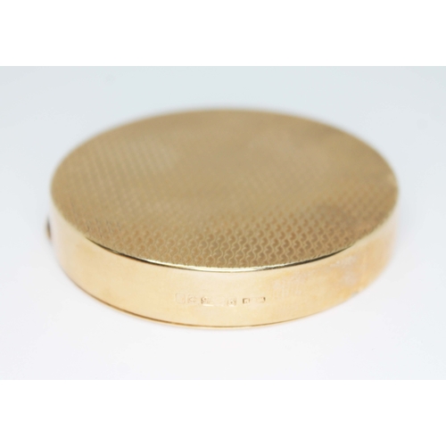 208 - A vintage 9ct gold compact, of round form, the top and bottom engraved with 'waves', cast thumb piec... 