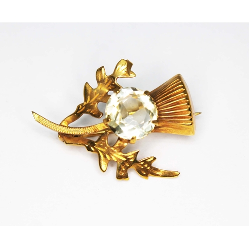 209 - A 9ct gold thistle brooch set with a citrine, Birmingham 1965, length 30mm, gross wt. 3g.