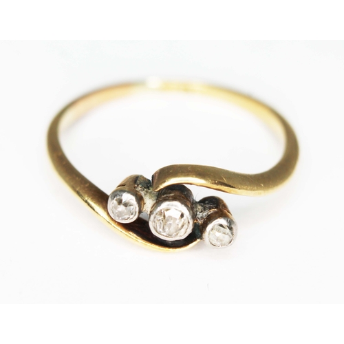 221 - A three stone diamond ring, marked '18c', gross wt. 2.4g, size P.