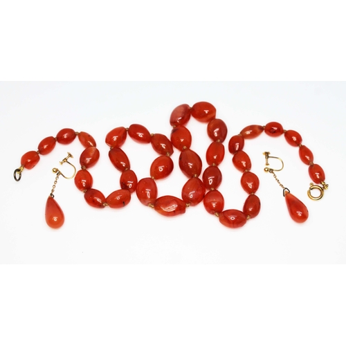 223 - A carnelian bead necklace and matching drop earrings set with clasp marked '9ct', necklace length 47... 