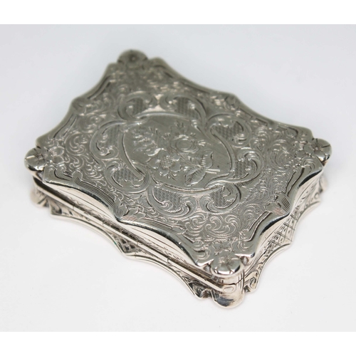 227 - An early Victorian silver vinaigrette, of scroll form and engraved all over, hinged lid revealing gi... 