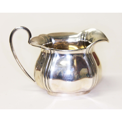 234 - A hallmarked silver cream jug, length 14.5cm, wt. 7ozt.