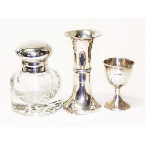 246 - Three items of silver comprising a glass jar, egg cup and a vase.