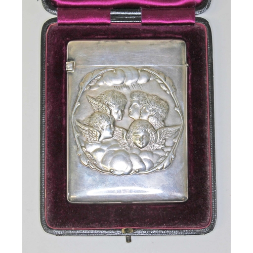 255 - A late Victorian silver card case embossed with cherubs, William Comyns & Sons, London 1897, 7cm x 1... 