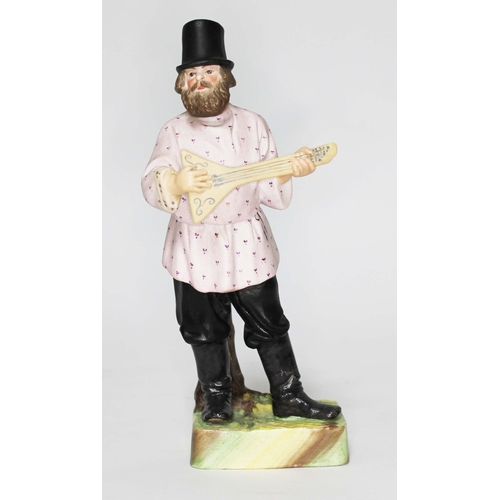 274 - A Russian Gardner Factory biscuit porcelain figure depicting a gentleman wearing a hat and playing a... 