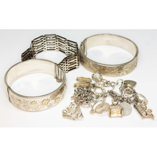 78 - A mixed lot of hallmarked silver comprising a pair of bangles, a gate bracelet and a charm bracelet,... 