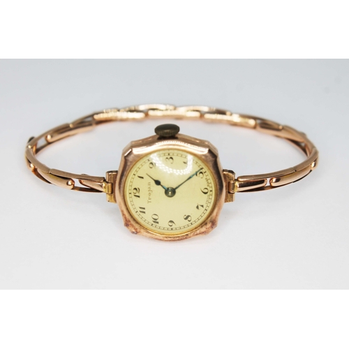 82 - A ladies hallmarked 9ct gold Trojan wristwatch with flexi strap marked '9ct', gross wt. 13.7g.