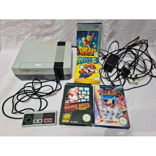 38 - A Nintendo Entertainment System (NES) with controller and games including Super Mario Bros and Super... 