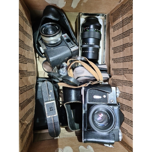 109 - A box of cameras & accessories to include Halina 3000, Zenit-E & a Pentagon lense etc.