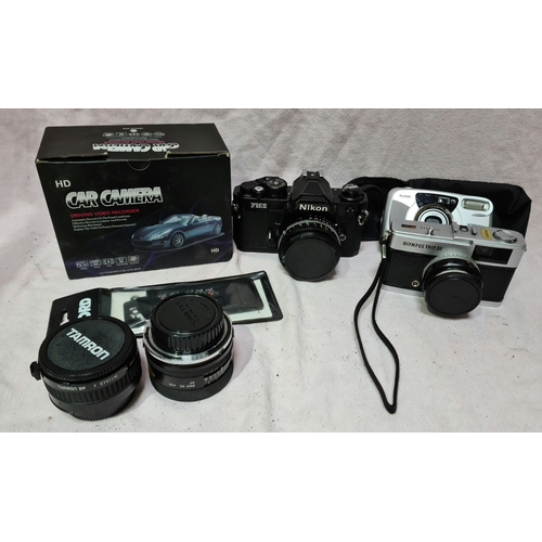 110 - A box of camera and lenses to include a Nikon FM2 SLR Camera, a boxed car camera, Olympus trip35 and... 