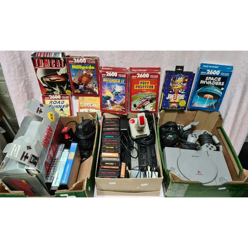 212 - Two Atari 2600 games consoles with assorted games, various Megdrive games and a PS1 with two control... 