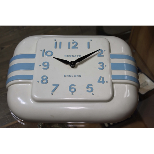 128 - A Cornish style blue and white plastic clock the dial marked 'Newgate England', length 38cm.