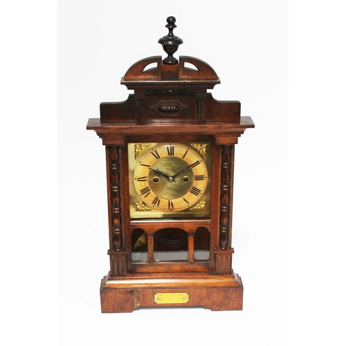 129 - A walnut mantle clock, height 58cm.