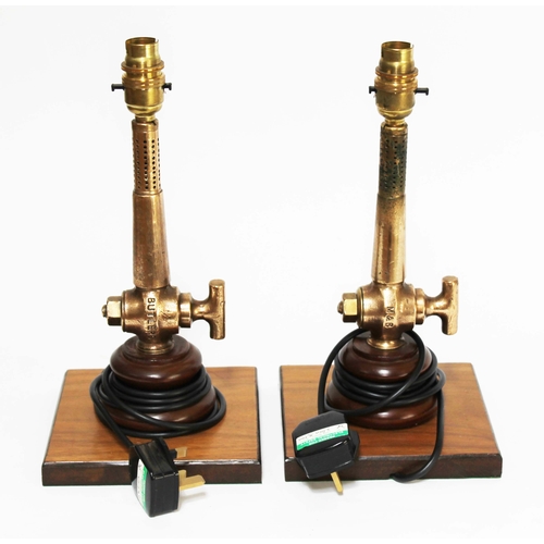 136 - A pair of cast brass table lamps formed from valves, on wooden bases, height 32cm.