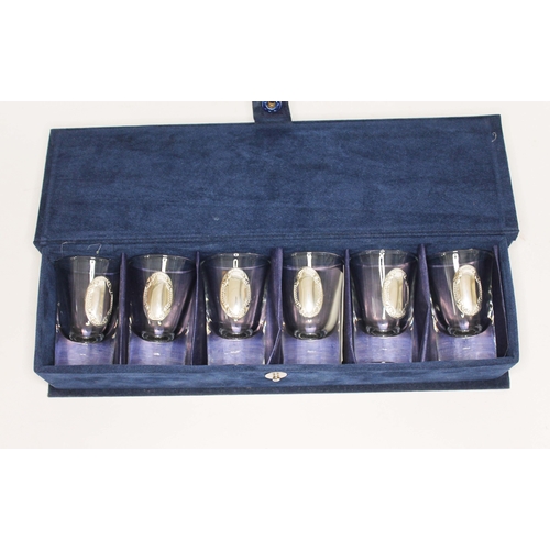 303 - A cased set of six glass shot glasses, each with applied Argentinian silver plaque.