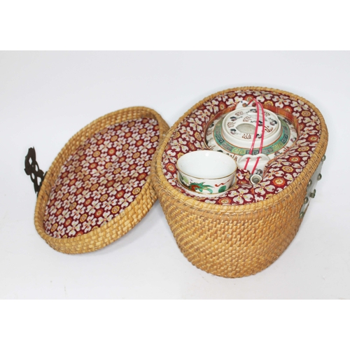 349 - A Chinese porcelain tea pot and tea bowls with basket.