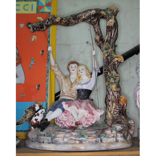 353 - A large Capodimonte figure group modelled as a girl and a boy on a swing, height 52cm.