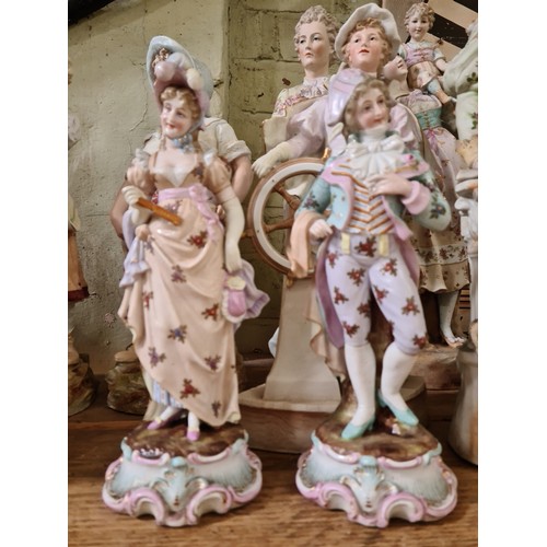 354 - A group of 14 porcelain figures comprising 12 bisque and another pair glazed, tallest 51cm.