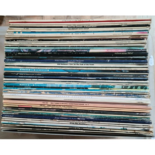 77 - A box of assorted LPs including The Beatles etc.