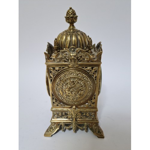 126 - A French pierced brass 30 day clock, striking on a bell, height 31cm.