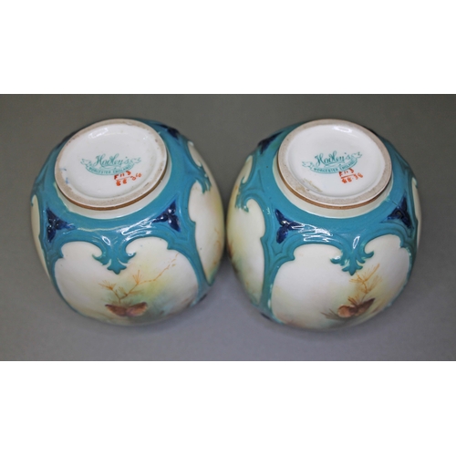 109 - A pair of Hadley's Worcester hand painted porcelain vase, decorated with birds and pine cones, heigh... 