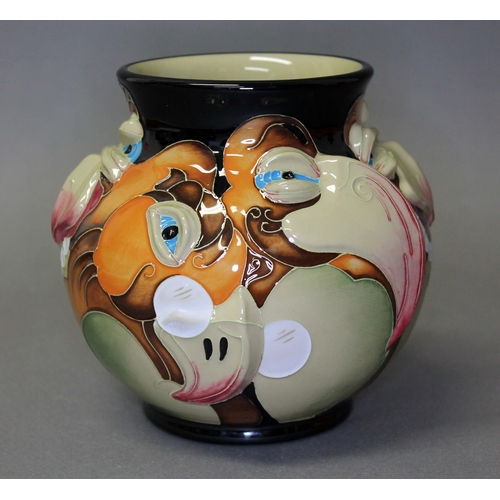 121 - A Moorcroft pottery vase by Emma Bossons, decorated with caricatures of bird faces, impressed and pa... 