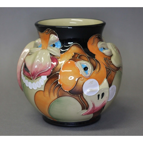 121 - A Moorcroft pottery vase by Emma Bossons, decorated with caricatures of bird faces, impressed and pa... 