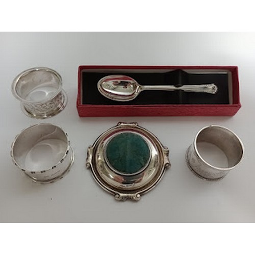 175 - Hallmarked silver items comprising three serviette rings, a teaspoon and a pin cushion.