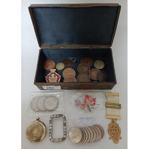 262 - An antique decorated metal box with contents to include coins, badges, etc.