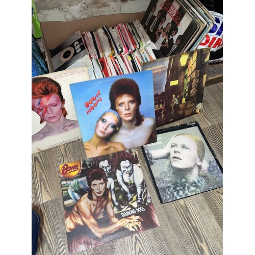 350 - A box of LPs and 45s to include David Bowie, Elton John, Queen, 10CC, etc.