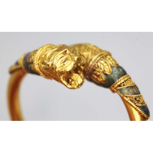 121 - A Western Asiatic lion headed bracelet, circa 5th - 4th century BC, cross over design of round cross... 