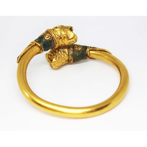 121 - A Western Asiatic lion headed bracelet, circa 5th - 4th century BC, cross over design of round cross... 