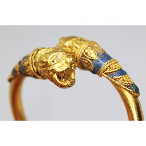 121 - A Western Asiatic lion headed bracelet, circa 5th - 4th century BC, cross over design of round cross... 