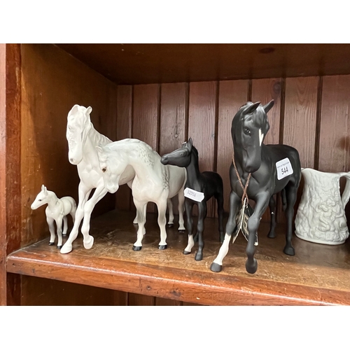 544 - Two white Beswick horses and a foal - good condition and two black Beswick horses - damaged