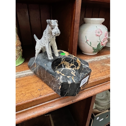 556 - Black veined marble ashtray with spelter dog. L20cm