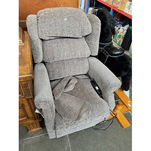 959 - A grey upholstered electric reclining armchair.