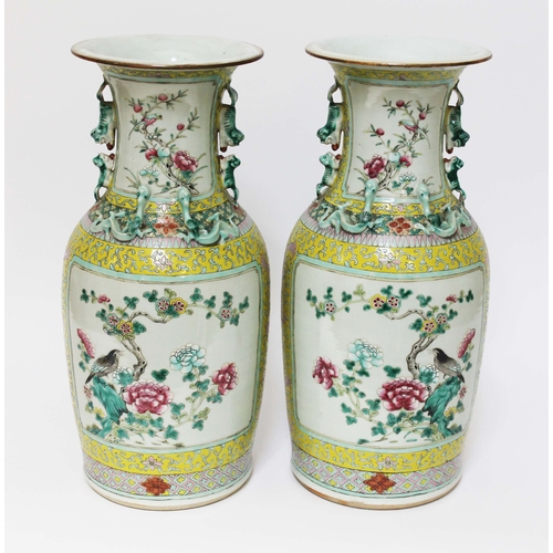 12 - A pair of Chinese porcelain famille jaune vases, mid 19th century, decorated in over enamels with bi... 