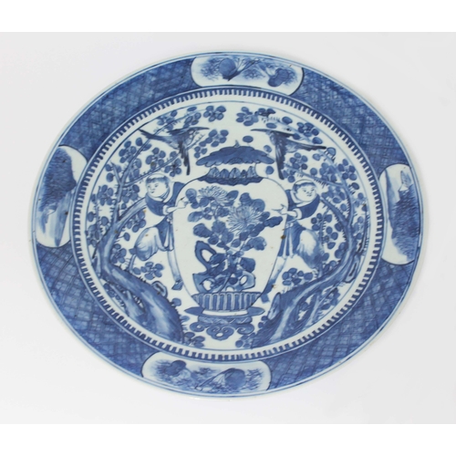 14 - A Chinese blue and white porcelain dish, 19th century, decorated with two men, birds and a vase, unm... 