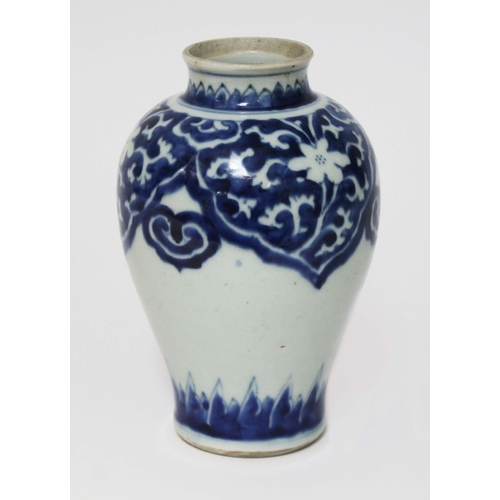 18 - An oriental blue and white porcelain vase, possibly transitional period, decorated with floral patte... 