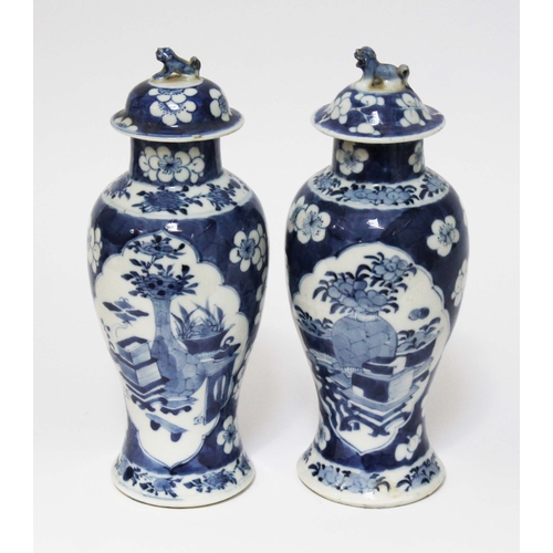 21 - A pair of Chinese blue and white porcelain vases and covers, circa 1900, each bearing four character... 