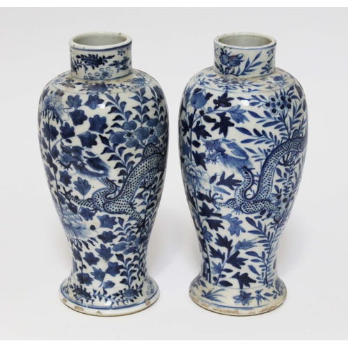 22 - A pair of chinese blue and white porcelain baluster vases decorated with dragons, each bearing four ... 