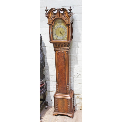40 - A good quality miniature long case clock, three train movement striking on eight gongs, brass and st... 