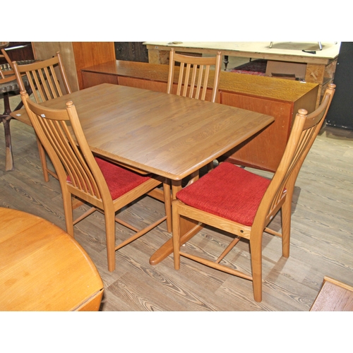 52 - An Ercol light ash extending dining table and four chairs.