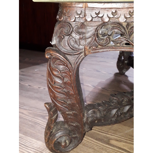 61 - A Chinese carved hardwood coffee table with onyx chess board top and resin pieces.