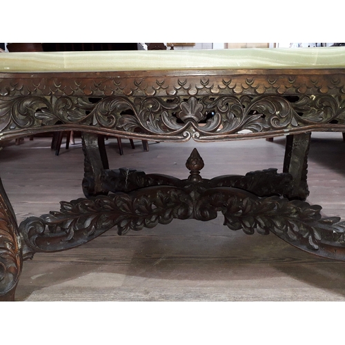 61 - A Chinese carved hardwood coffee table with onyx chess board top and resin pieces.